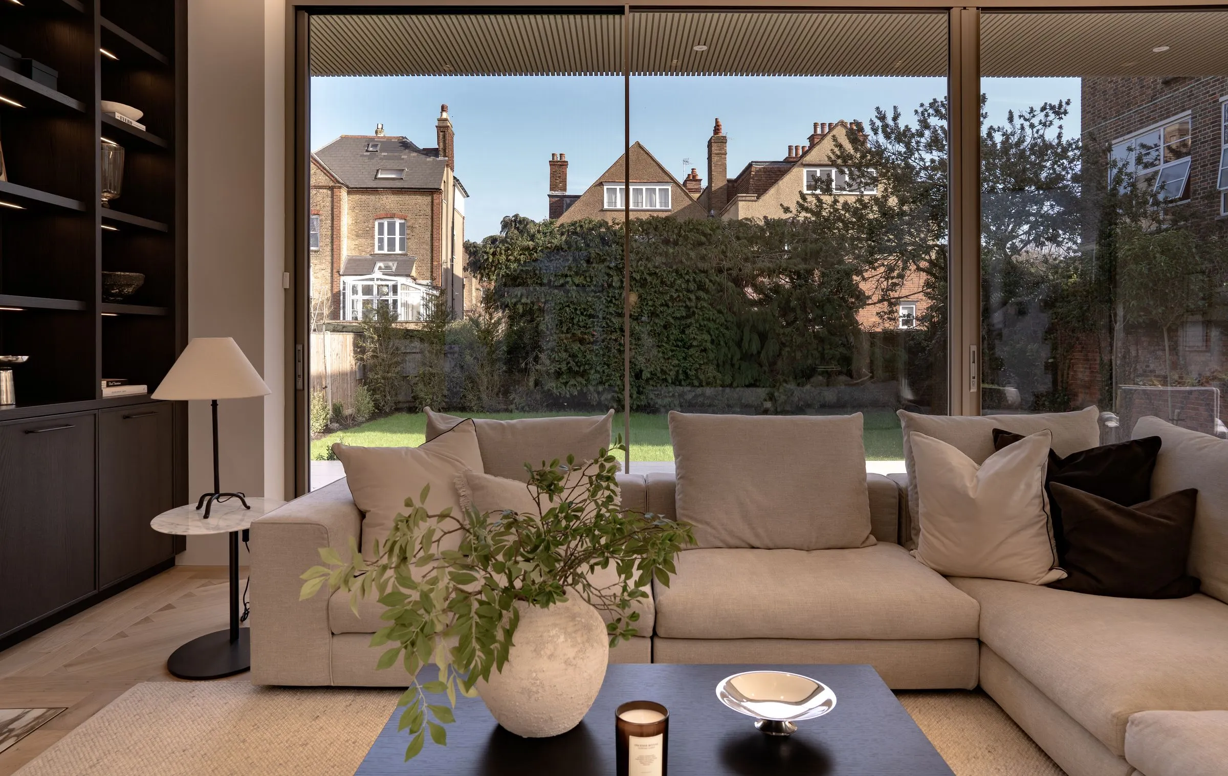 Sofa facing a wide glazed sliding door and garden